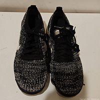 Front view of Nike VaporMax sneakers showing knit fabric upper and laces.