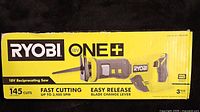 Photo of labeled box for Ryobi 18V ONE+ Reciprocating Saw showing key features like 145 cuts, fast cutting speed up to 3,400 SPM, and easy release blade change lever.
