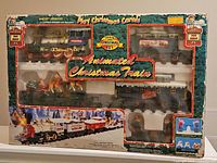 Full boxed vintage animated Christmas train set showing all train components and festive packaging