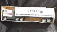 Side view of complete semi truck and trailer in box showing Gerber branding and overall condition.
