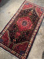 Full view of rectangular rug showing central medallion and border