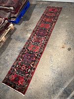 Full-length view of runner rug laid flat on concrete floor