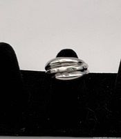 Front three-quarter view of the ring showing domed band design and etched lines.