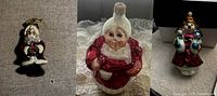 Photo showing three Radko glass Christmas ornaments: Mr. Santa Claus, Mrs. Claus, Mrs. Iceberg with children.