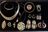 Front view of lot showing all jewelry pieces arranged on black background