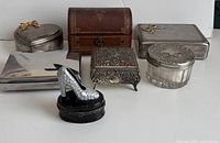 Front view showing all six trinket boxes including shoe, wooden, silver-plated, and glass combination box.