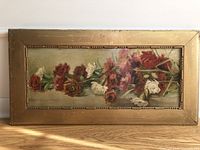 Full view of antique Victorian still life flower painting with original gold frame on wood surface.