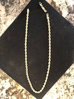 Full-length view of rope chain necklace with broken ends and lobster clasp removed