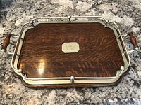 Overall top view of tray showing oak surface, metal gallery rail and handles