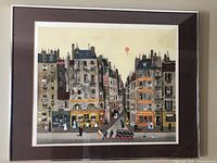 Full frontal photo of rare lithograph "Le Défilé" by Michel Delacroix showing detailed Paris buildings with a parade of soldiers.