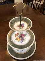 Full view of the assembled 3-tier cake stand showing all three plates and brass handle