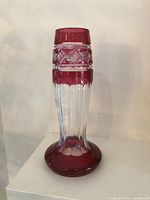 Front view of crystal vase showing ruby colored top and base with clear cut crystal body