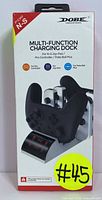 Front of the box packaging showing DOBE multi-function charging dock designed for Nintendo Switch controllers including Joy-Cons, Pro Controller, and Poke Ball Plus, with LED indicators.