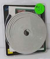 Top-down photo showing the coiled white LED neon flexible strip light still sealed in its original packaging.