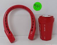 Red neck fan and Coca-Cola branded portable bottle shown side by side on a plain background