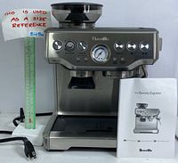 Front view of espresso machine showing control panel with analog pressure gauge, grind amount and filter size dials