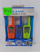 Three Midland X-Talker two-way radios in original packaging showing orange, blue, and green units.