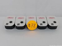 Set of five identical ultrasonic pest repeller units arranged in a row, showing front faces with label and QR code visible.