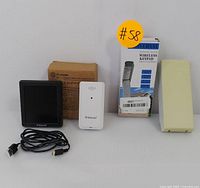 Geevon weather station with outdoor sensor, USB cable, boxed wireless garage door keypad, and an additional beige rectangular item.