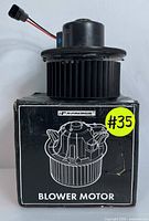 Side view of the assembled blower motor mounted on its original box showing the electrical connector and wiring.