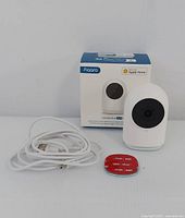 Front view of Aqara Camera Hub with USB power cable, red 3M mounting pad, and original Aqara box