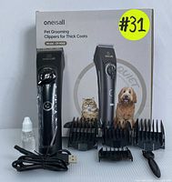 Set with cordless pet clipper, five guard combs, USB charger, blade oil, cleaning brush, and original packaging.