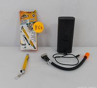 Photo showing yellow digital tire pressure gauge branded Armor All in original packaging, loose yellow tire pressure gauge, and black portable tire inflator with hose and valve attachment.