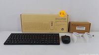 Overall lot showing wireless keyboard, mouse, two USB receivers, USB power cord, and original packaging.
