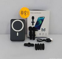 Wireless lavalier microphone set transmitters, receiver, multiple clip mounts, USB charging cable, and MagSafe power bank displayed with microphone box and yellow lot sticker.