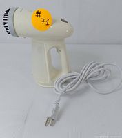 Side view of the Bear handheld steamer showing ergonomic handle, power cord and steamer body with sticker #71