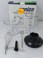 Full set of 5-in-1 hand blender accessories displayed in front of original Boniza branded box. Items include whisk, small frother, plastic chopper lid, and two mixing/measuring cups.