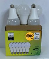 Pack of six Master LED A25 light bulbs displayed on top of the original packaging box showing three bulbs standing upright and the box front.
