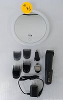 Photo showing entire set including rechargeable hair clipper, multiple guard attachments, precision trimmer, charger, and 10X magnifying mirror.