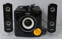 Earson 2.1 channel speaker system complete set showing subwoofer and two satellite speakers, all in black.