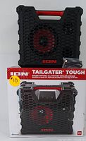 Front and top view of the black and red rugged ION Tailgater Tough Bluetooth speaker next to its original box and charging cable.