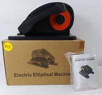 Elliptical trainer placed on top of original cardboard box with user manual packaged in plastic bag next to it.