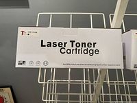 Close-up photo showing one laser toner cartridge box with label '125 131 BK' and 'Laser Toner Cartridge' text.
