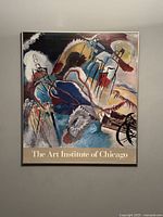 Full front view of the framed poster hanging on the wall showing the abstract colorful composition and The Art Institute of Chicago text at the bottom.
