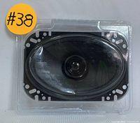 Front view of Boss Audio Systems BRS46 4x6 speaker in plastic packing showing the speaker cone and mounting holes.