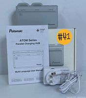 Potensic ATOM Series Parallel Charging Hub with user manual, box, and power adapter visible
