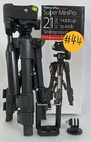 Folded Sunpak Super MiniPro tripod in front of original box showing product details and branding.