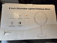 Photo showing the box of the 8 inch dimmable lighted makeup mirror with features printed on box.