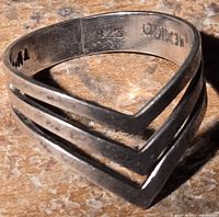 Close-up photo of the sterling silver ring showing the geometric open V design and the interior stamps .925 and Mexico