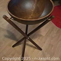 Photo of the entire vintage wooden salad bowl with its tripod wooden stand, showing the bowl's interior and exterior finish, and the structure of the stand.