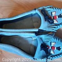 Top angle view showing the moccasins' beadwork on suede material.