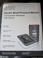 Box front showing DrKEA+ branding, model JPD-HA101, features including backlit LED screen, pulse rate indicator, and dual user memory.