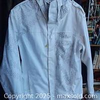 Front view of white Oakley jacket showing circular pattern design