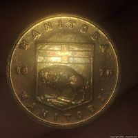 Close-up front view of the Manitoba token showing buffalo and provincial shield, dated 1970