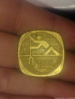 Front side of the square gold-colored coin showing a paddling figure and 'PADDLE CANOEING' text