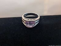 Front view showing the sterling silver band with a rectangular faceted amethyst stone set in the center.